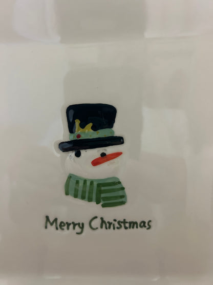 White square Christmas plate close-up of snowman cut-out and “Merry Christmas”