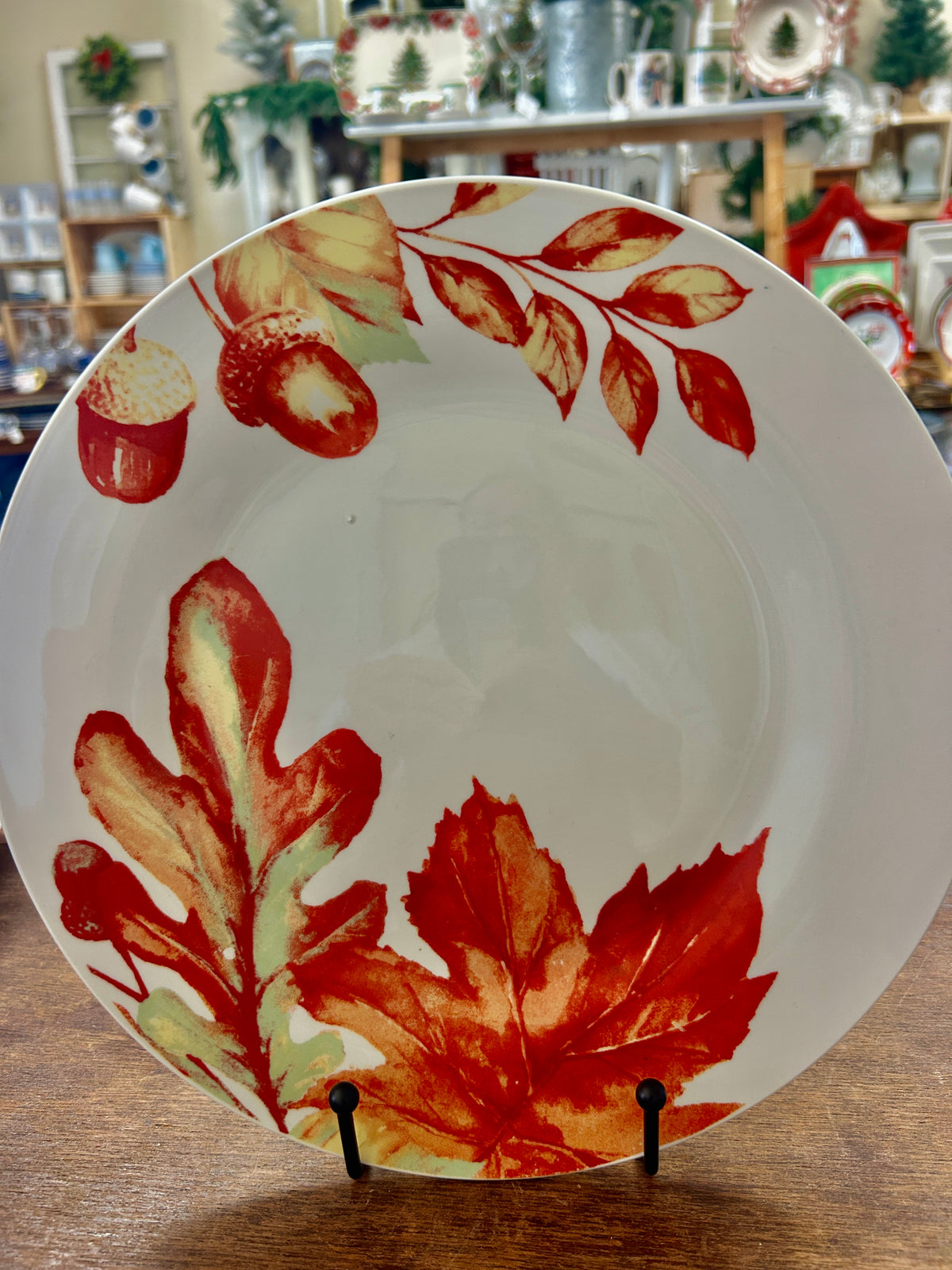 White dinner plate with red, orange, and green autumn leaves design