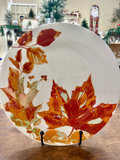 Ceramic dinner plate with multicolor autumn leaves design on white background