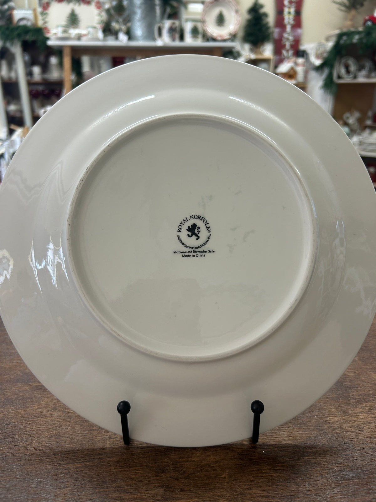 White ceramic dinner plate with stamped maker mark on the back