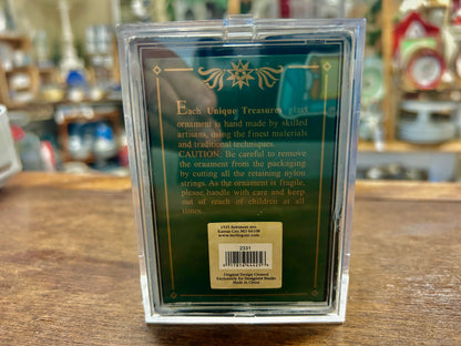 Back of Santa glass ornament in clear box with printed care text and barcode