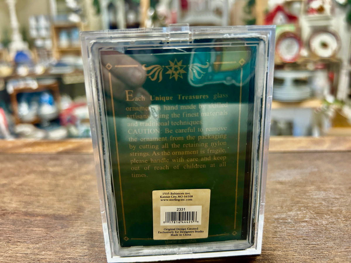 Back of clear ornament box with decorative panel and barcode sticker