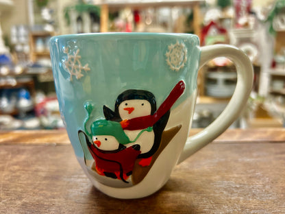 Blue and white Christmas mug with St. Nicholas penguin and red scarf graphic