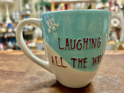 Blue and white Christmas mug with "Laughing All the Way" text in red