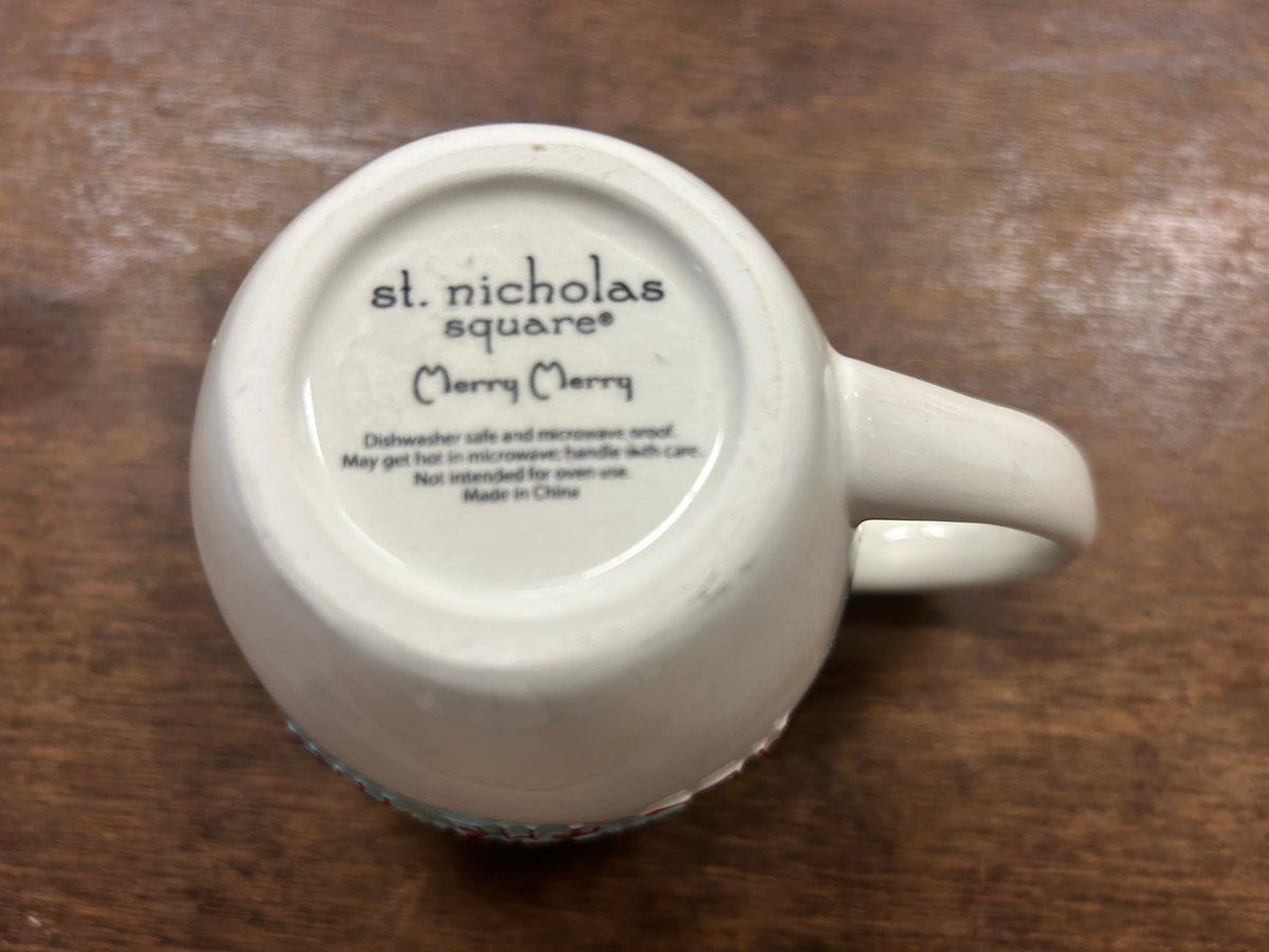 Bottom of blue and white Christmas mug with "st. nicholas square" stamp