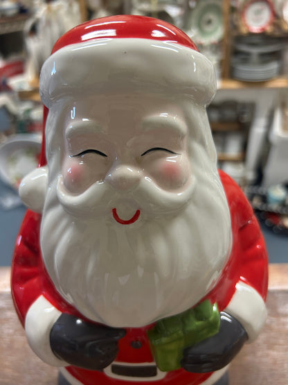 Santa cookie jar close-up, smiling face with white beard and red hat