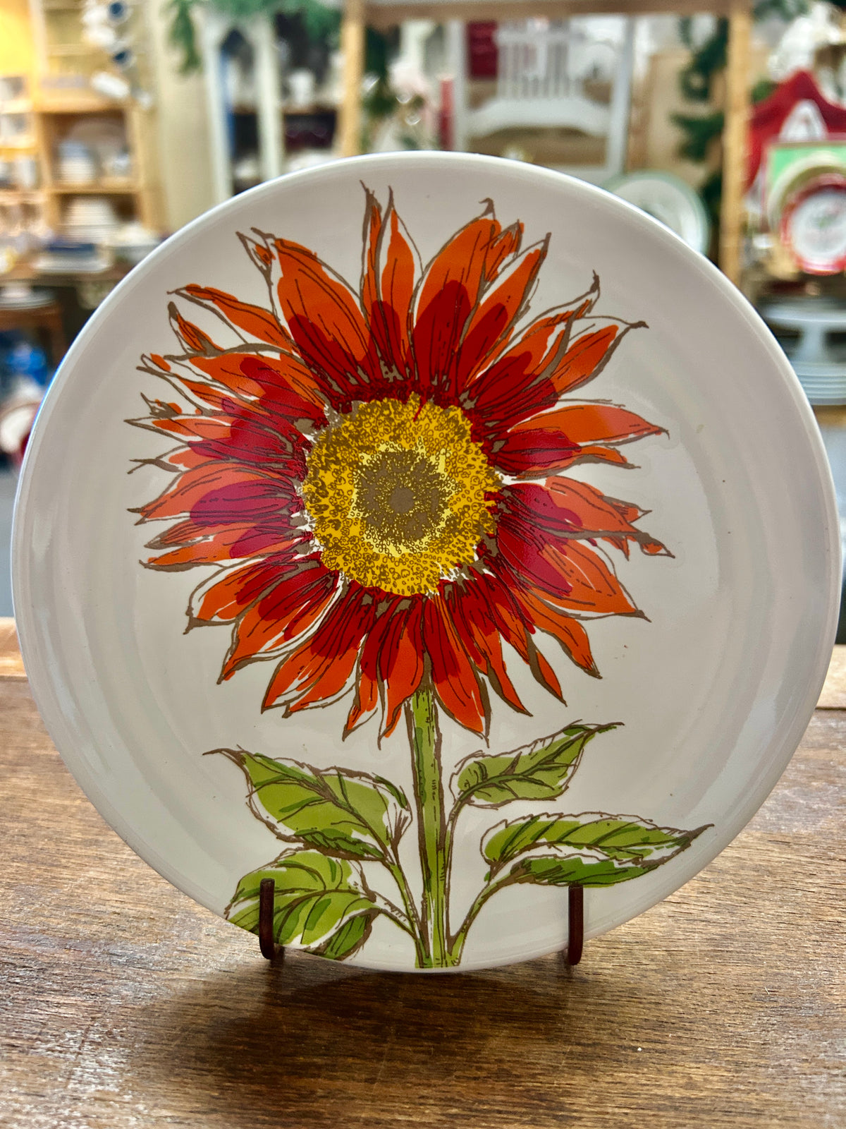 White 6-inch sunflower plate with red-orange petals and yellow center
