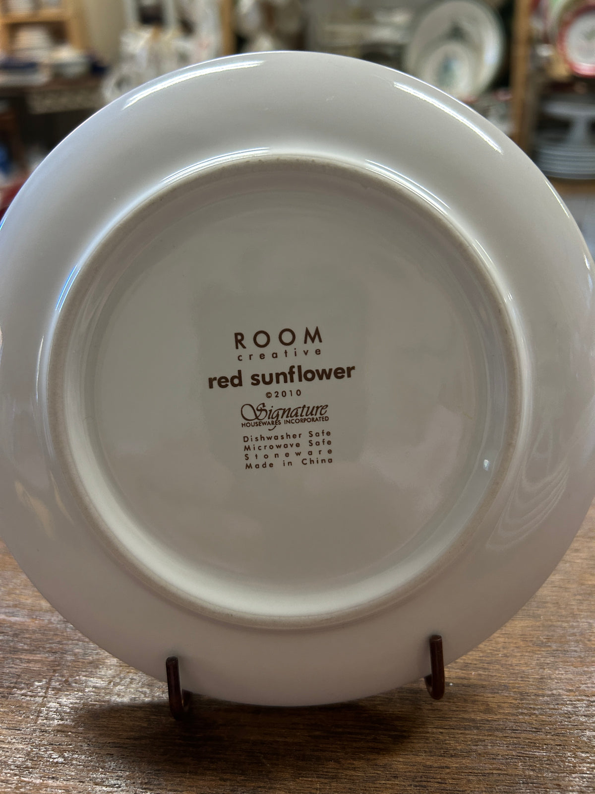 White plate back with printed 'Room', 'red sunflower', and Signature text