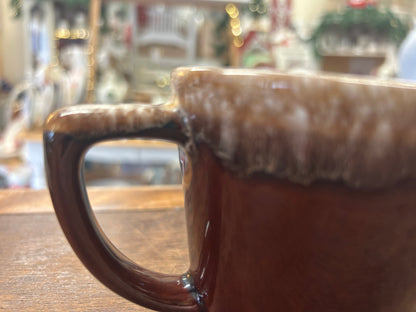 Brown ceramic mug with speckled rim, glossy finish, and C-shaped handle