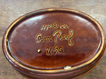 Brown ceramic baking dish base with HP Co and Custom markings