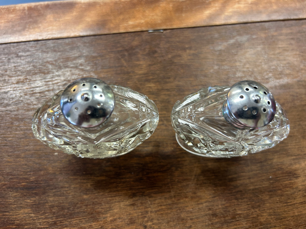Vintage clear glass salt & pepper shakers, view of perforated metal lids