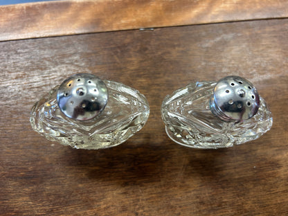 Vintage clear glass salt & pepper shakers, view of perforated metal lids