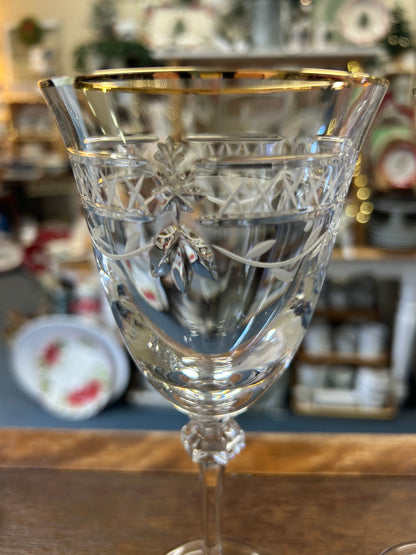 Clear crystal wine glass with gold rim and etched decorative pattern