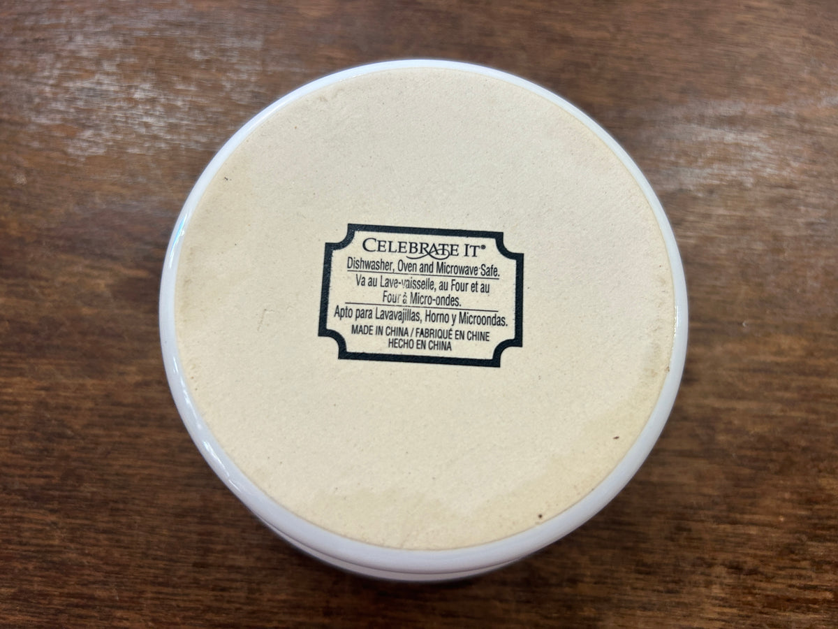 Bottom of white 4-inch snowman bowl with Celebrate It label