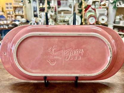 Pink ceramic serving platter underside with Nora Fleming and Fiesta USA marks