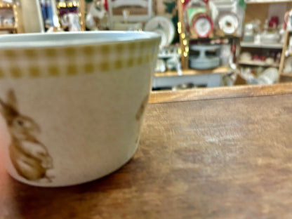 Green and white ceramic bowl side view with bunny graphic
