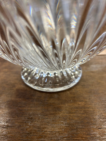 Clear crystal shell bowl close-up, faceted fluted pattern and scalloped rim